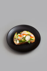 Open Sandwich with Cream Cheese, Avocado, Hotate, Radit, Tomato and Tobiko Eggs.