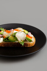 Open Sandwich with Cream Cheese, Avocado, Hotate, Radit, Tomato and Tobiko Eggs.