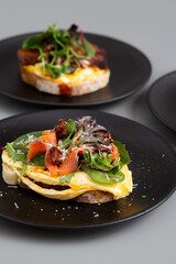 Open Sandwich with Salmon Gravlax, Cucumber, Scrambled Egg, Tatar Sauce and Olive oil.