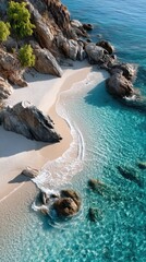 Top Down Aerial View of a Serene White Pebble Beach with Turquoise Ocean Water Sparkling Under Sunlight Lush Greenery on Rocky Cliffs