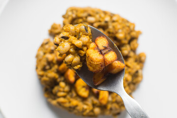 Overhead view of nigerian fried beans and fried plantain on a white plate, top view of nigerian stewed beans and plantain