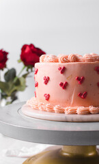 Peach buttercream cake on a cake plate, valentines Cake covered in red buttercream hearts