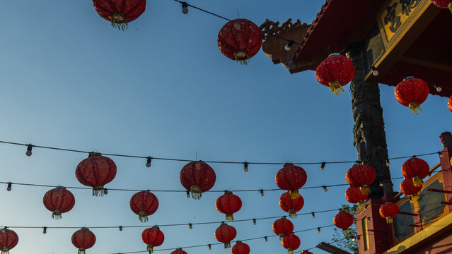 Rows of red and gold paper lanterns hanging in temple