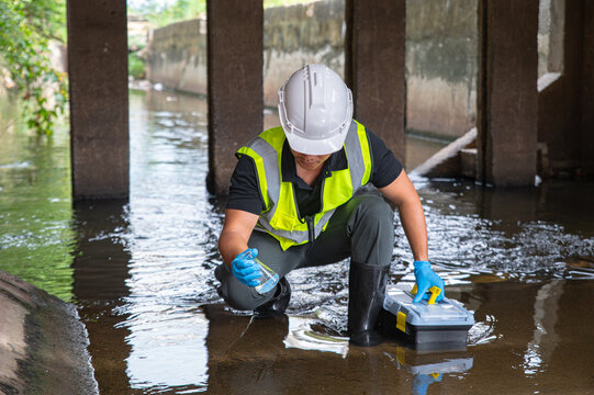 Environmental Scientist Collecting Water Samples Under Bridge for Quality and Pollution Control
