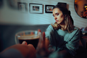 Woman Refusing a Cup of Coffee the Host Offered Her. Guest having to decline a cup of caffeinated...