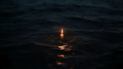 Eerie candle flame flickers on dark water, creating a somber, reflective mood for remembrance or mourning themes with deep emotional resonance