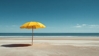Bright yellow beach umbrella standing alone on a calm sandy shoreline under clear sky
