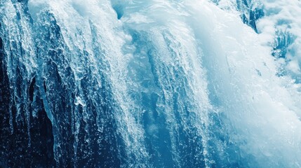 Waterfall cascades with vibrant blue hues in a forested area during daylight hours