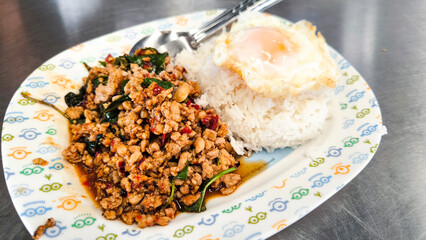 Thai basil minced pork with fried egg on rice, popular Thai street food dish