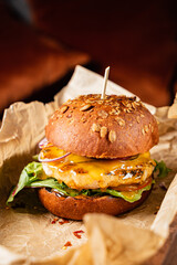 Savory veggie burger with a tender patty, melted cheese, and fresh greens in a wholesome bun