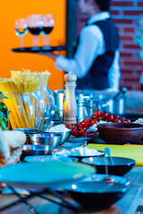 A chef arranges fresh ingredients and tools, creating a vibrant cooking atmosphere