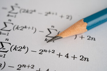 Pencil on mathematic formula exercise test paper in education school.