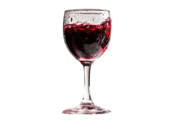 Red liquid splashing in a clear glass