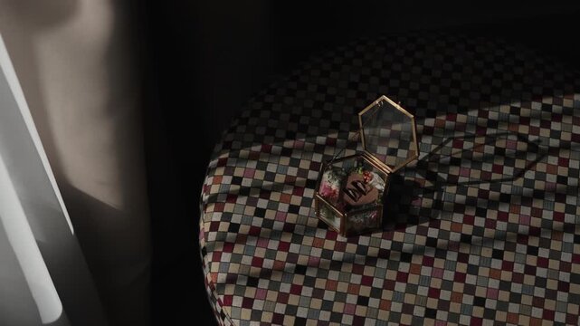 Intimate reveal of ornate trinket box evoking tender memories in soft light