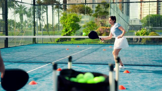Padel, training and coach with woman, court and practice for challenge, fitness and lesson for sport. Coaching, tennis player and people with rackets for skill development, tournament and workout