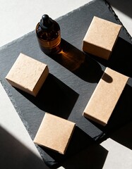 Amber glass dropper bottle with small cardboard boxes on a dark slate surface