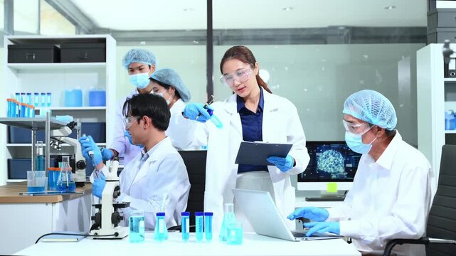 Scientist team meeting and writing analysis results in the laboratory study and analyze scientific sample