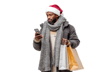 Bearded Black man in winter jacket, gray scarf, and red Santa hat checking smartphone while holding white and brown shopping bags, holiday gift hunting