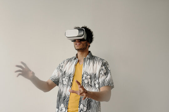 Horizontal waist up portrait shot of African American student using VR set
