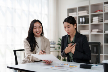 Business women discussing financial report showing impressive results