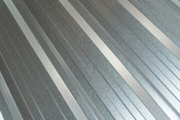Close-up view of a new corrugated metal sheet with a shiny galvanized surface, perfect for roofing, wall cladding, or industrial background texture.