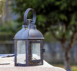 old oil lamp on a wooden fence