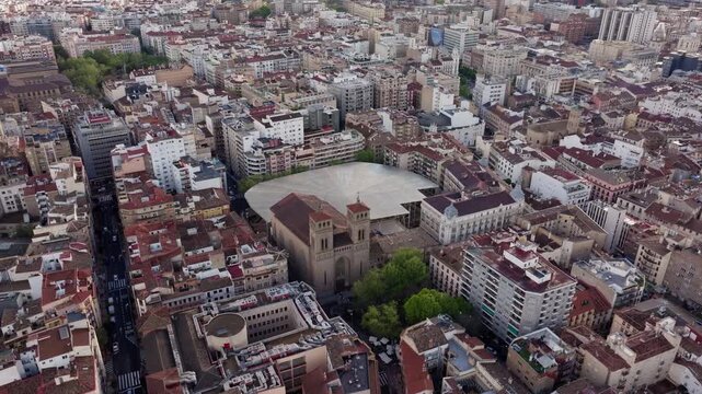Aerial rotating view of the historic district of Zaragoza, Spain. Dense urban landscape with rooftops, buildings and a church