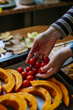 Cherry tomatoes placed beside pumpkin slices