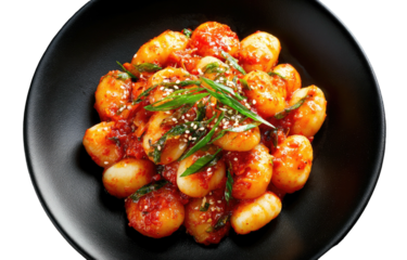 Spicy, savory rice cakes with green onion and sesame seeds