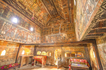 Maramures, Romania - Aug 14, 2025: Folk Baroque wooden ceiling painting of angels and saints in historic Leud Hill Church, Maramures, Romania. UNESCO heritage interior