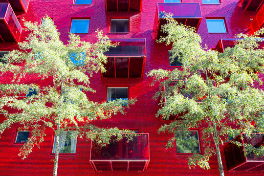 Modern urban architecture with green facade and vegetation integrating sustainable residential landscape design in Norradjurgardsstaden district of Stockholm under soft daylight atmosphere