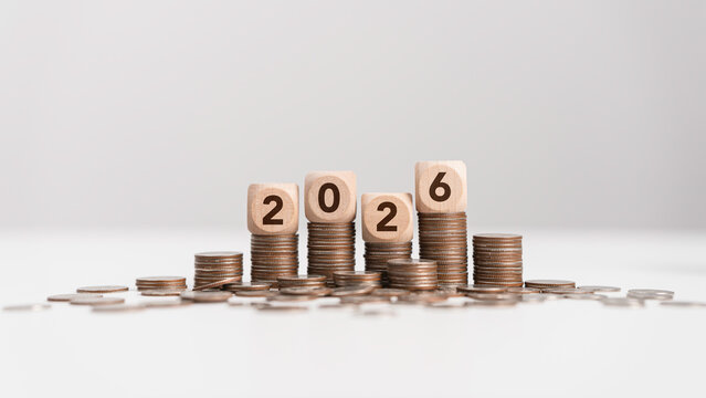 Stacks of coins with wooden blocks forming number 2026 for target financial growth, investment planning for money savings to wealth, business goals concept. Budget and tax, Happy new year 2026
