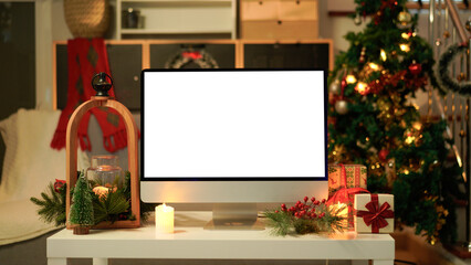 Modern computer monitor with blank screen on festive decorated table