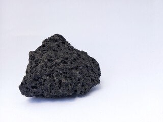 Black porous rock isolated on white