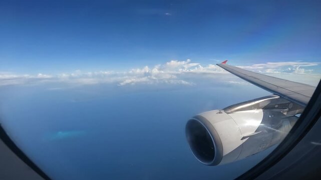 Footage of an airplane flying over the sea looking through an airplane window. The wing is responsible for generating the primary forces that enable flight.