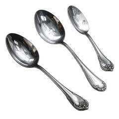 Three ornate, highly polished spoons of varying sizes, arranged diagonally on black