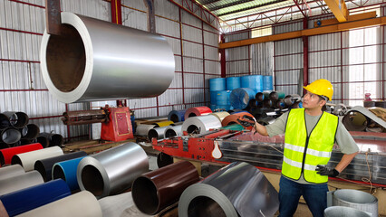 Industrial worker operating machinery in manufacturing facility steel processing well-organized environment