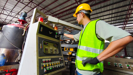 Industrial worker operating machinery in factory action scene close-up view industrial environment