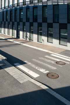 Intersection of empty streets within modern architecture and visible infrastructure creating an urban perspective, urbanscape design showing balance between shadow, light and space