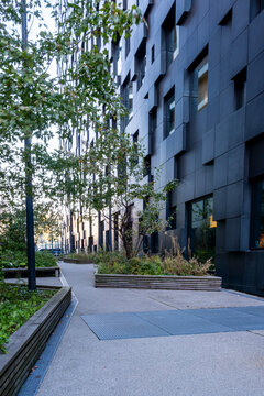 Wide empty street crossing through modern architecture and infrastructure perspective in bright daylight, capturing an urban city composition with contemporary urbanscape design balance