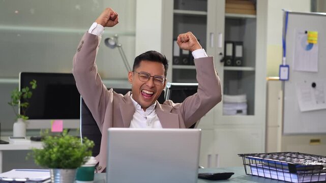 Overjoyed, Asian male businessman celebrates a financial bonus. joyful smile, money success.