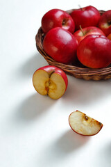 Basket of red apples with one cut apple and slice