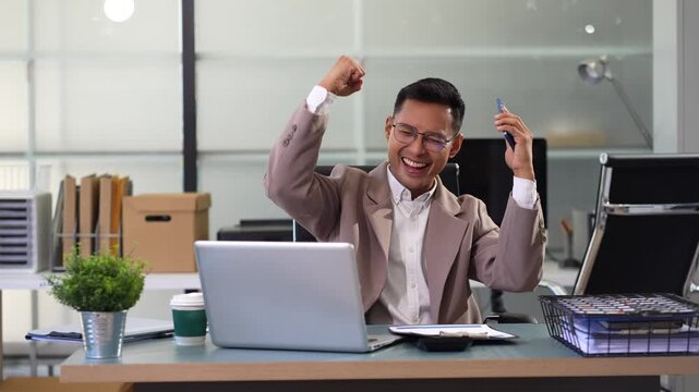 Overjoyed, Asian male businessman celebrates a financial bonus. joyful smile, money success.