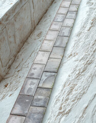 Stone pathway lined with rough textured walls