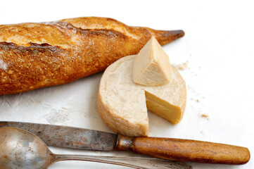 Rustic baguette and cheese with vintage utensils