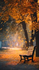 Wooden bench in serene park surrounded by autumn leaves on a calm afternoon
