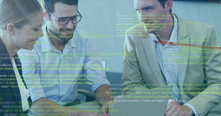 Three developers in business casual reviewing code in office, with laptop and code projection