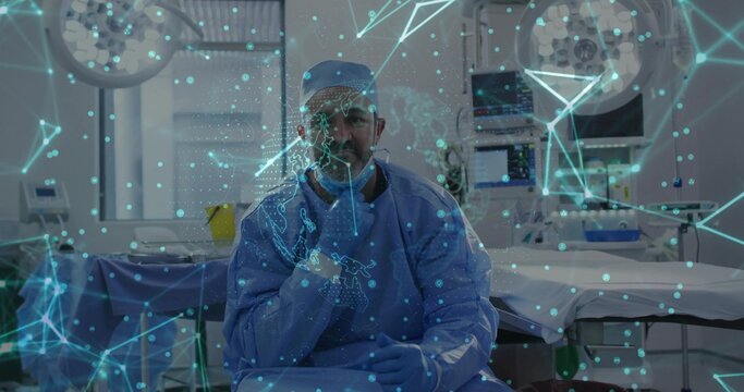 Operating surgeon in blue scrubs in operating room on bed, with holographic overlay lights monitors