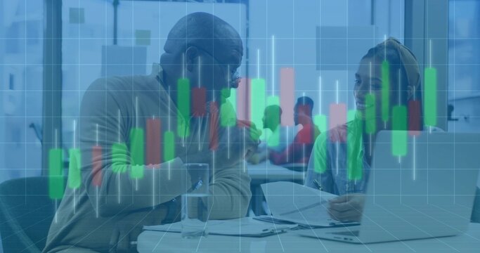 Discussing financial data two professionals at office with laptop documents and candlestick overlay