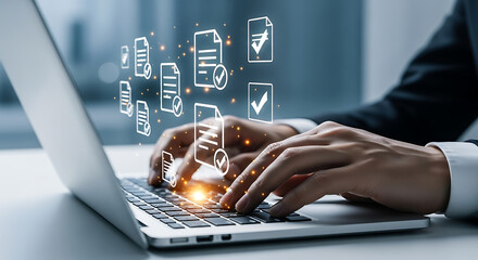 Business person using a laptop with document icons with checkmarks representing document management, quality control, and digital workflow.